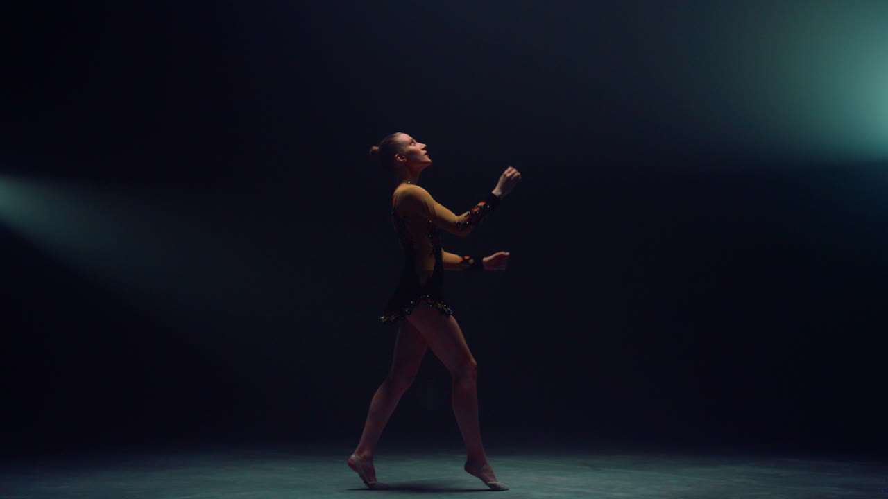 Athletic woman tossing up hula hoop. Graceful gymnast training sport equipment.