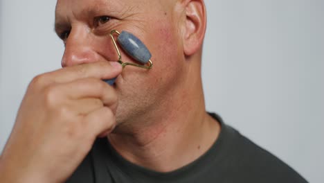 man performing facial massage and ear cleaning