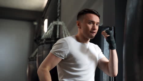 strong athlete man workingout and training with a punching bag