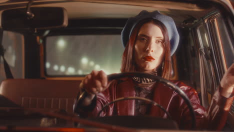 young attractive woman smoking and driving retro car in night city