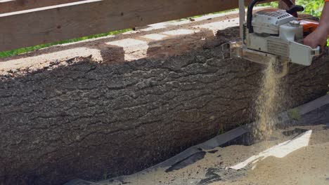 Medium-shot-of-a-chainsaw-creating-a-lot-of-sawdust-at-a-logging-mill