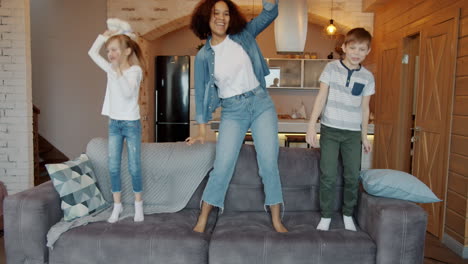 happy family dancing on couch