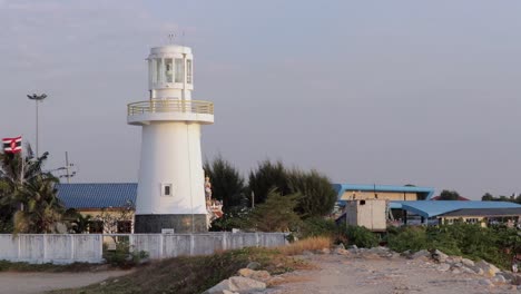 historical lighthouse in the fishing port of paknam in rayong river, eastern thailand