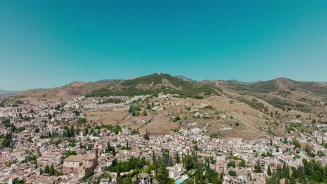 Aerial-drone-shot-of-the-city-of-Granada-in-Spain-flying-towards-the-mountain,-Granada,-Spain,-4k