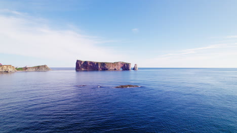 Luftaufnahme-Einer-Drohne-Mit-Rückwärtsverfolgung-Des-Percé-Felsens-An-Einem-Sonnigen-Tag