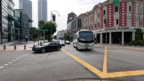 vehicles moving through a crosswalk in the city.