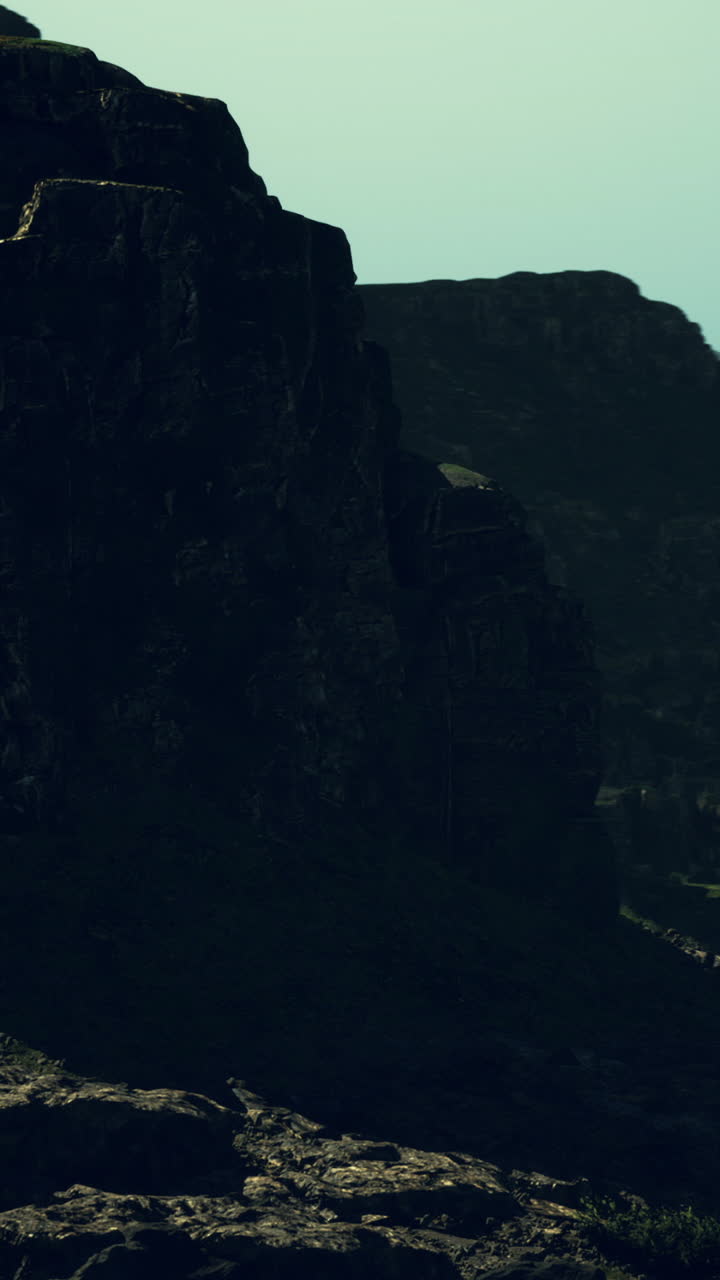 Majestic rocky formations under a dramatic sky at dusk