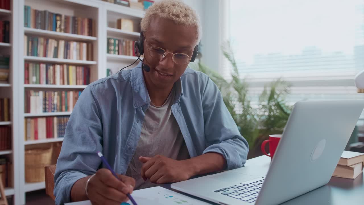 African american man holding a voice conference through wired headset