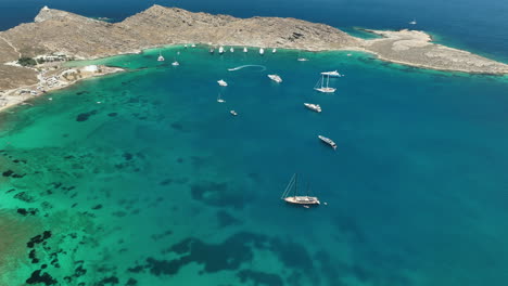 birds eye view above a secluded cove with yachts in paros, greece