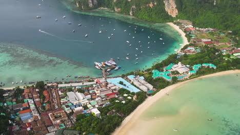 various boats moving around a tropical constructed beach in thailand