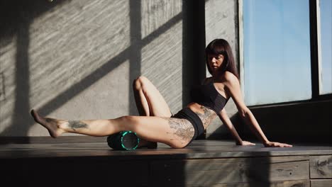 woman performing foam rolling exercise