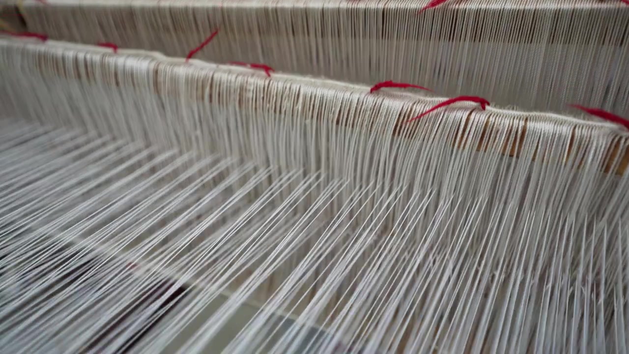 Close up of multicolored thread spools and yarn rolls for professional garment production and crafts