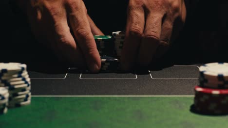 hands managing poker chips on green table, reflecting intense poker gameplay with the element of chance and skill