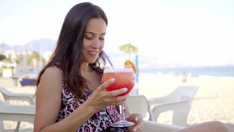 Happy-friendly-woman-drinking-a-tropical-cocktail