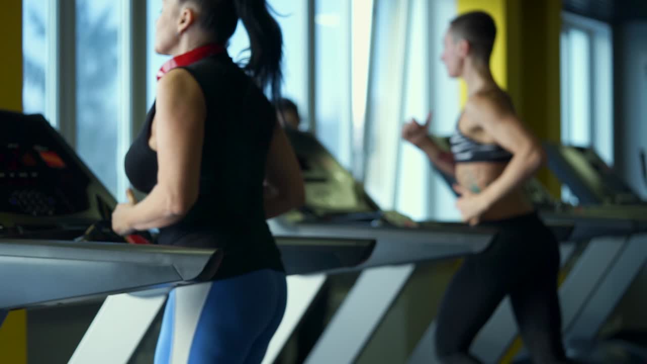 Women working out on treadmills in a gym