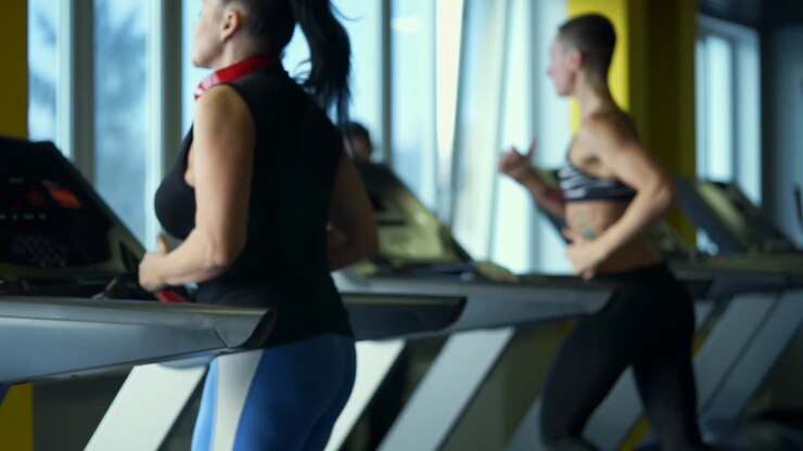 Women working out on treadmills in a gym