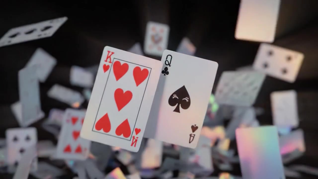 A Mesmerizing Display of Falling Playing Cards in a Darkened Room Captivates the Viewer, Creating a Magical Atmosphere of Chance and Excitement.