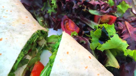 tasty chicken wrap with vegetables and a salad on the side on a white plate in marbella spain