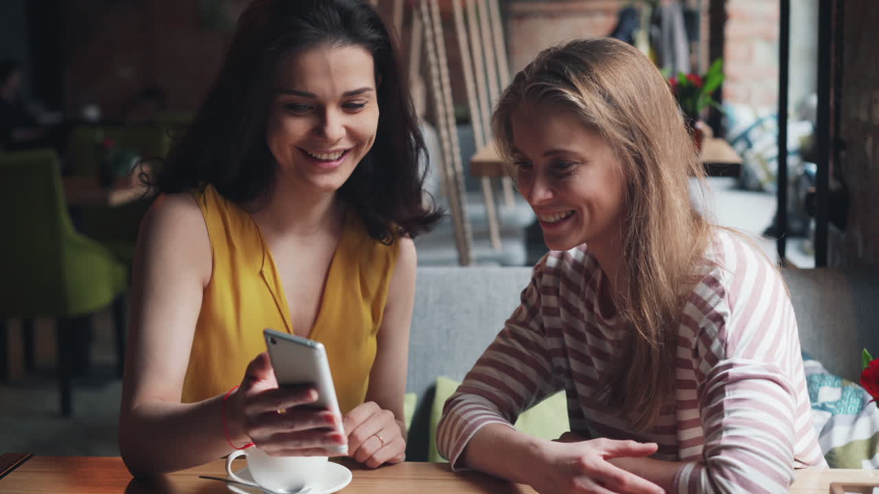 Two Women Friends Enjoying Time in a Cafe