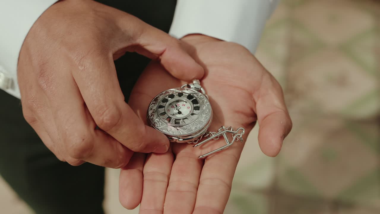 hands reveal intricate vintage pocket watch with gentle care