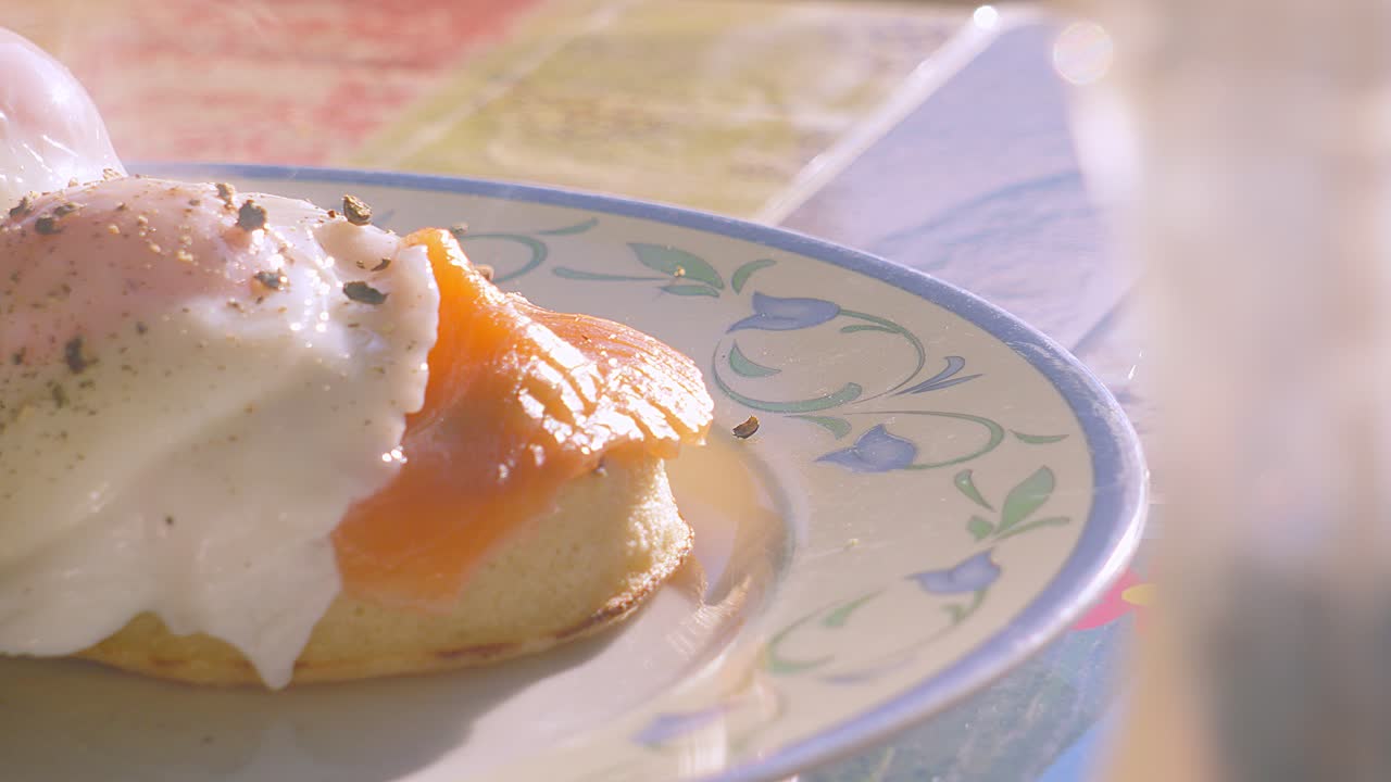 Shallow DOF Breakfast of Crumpet with Smoked Salmon Topped with Peppered Poached Egg. Morning High Protein Healthy Stylish Food Brunch Footage 4K.