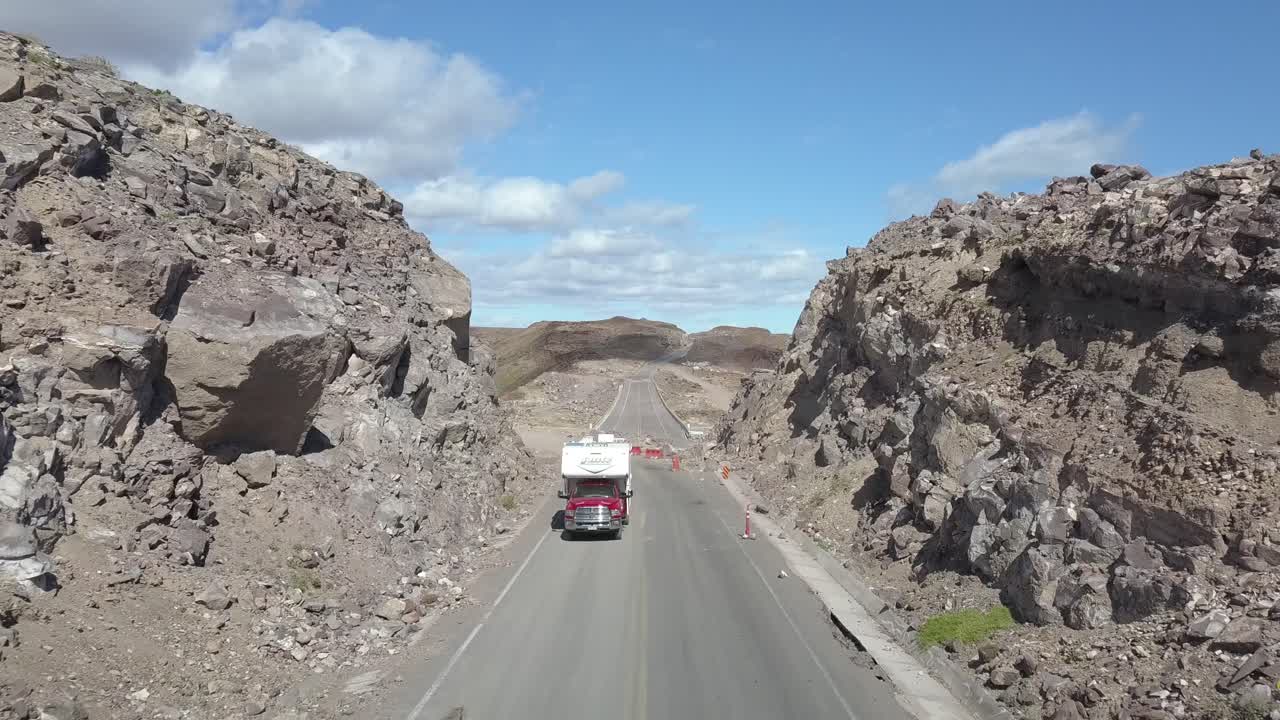 Aerial push over road revealing erosion of road from flooding.