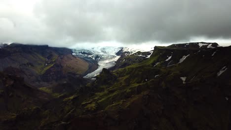 Aerial-panoramic-view-of-mountains-and-glacier-landscape,-in-the-Fimmvörðuháls-area,-Iceland