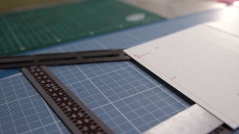 Cutting table for leather segments showing cutting guides, mats and guides , Dolly out close up shot