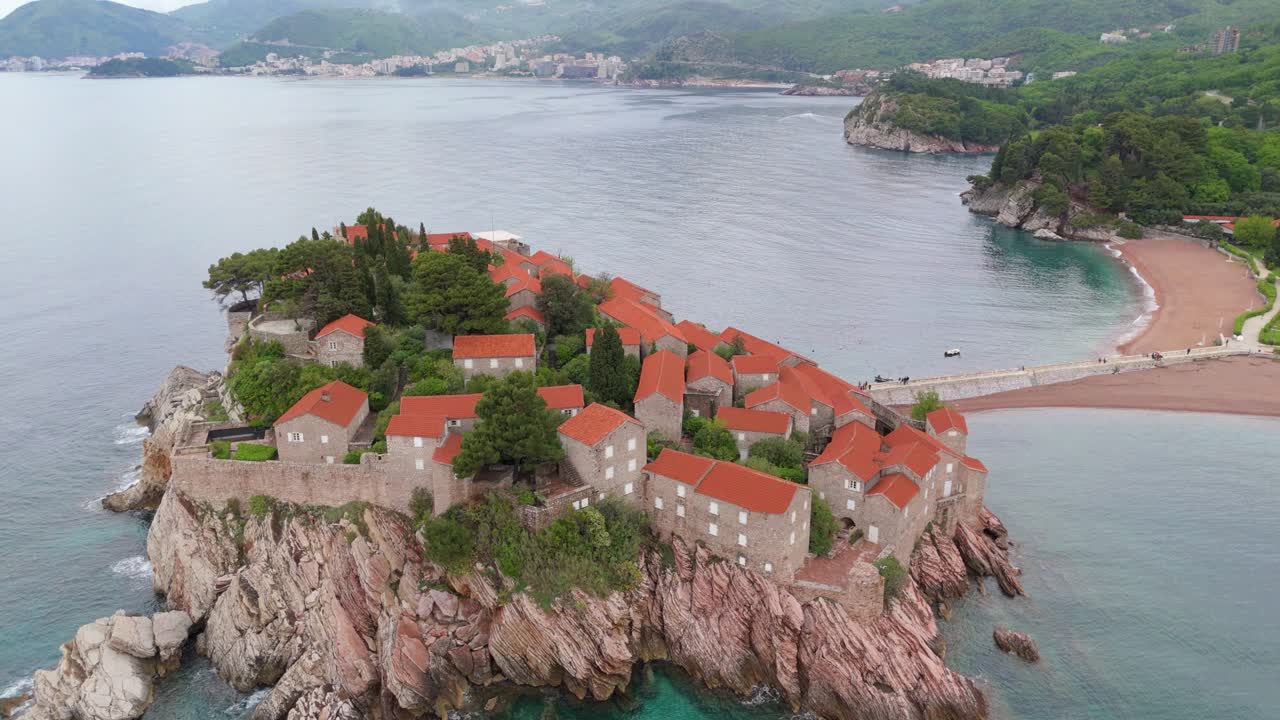Scenic Aerial Shot of Sveti Stefan Coastal Village Montenegro Featuring Historic Stone Villas and Ocean Views