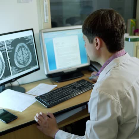 doctor working at the hospital. neurologist working on personal computer in modern laboratory