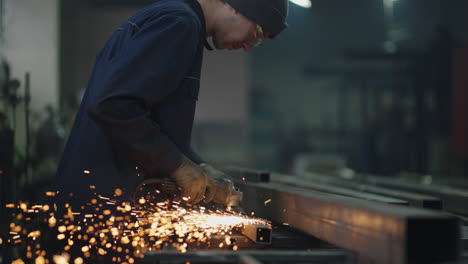 man works circular saw. sparks fly from hot metal. man hard worked over the steel. slow motion. sparks from working with steel.