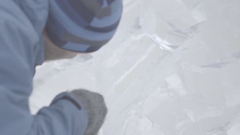 ice sculptor carving a block of ice