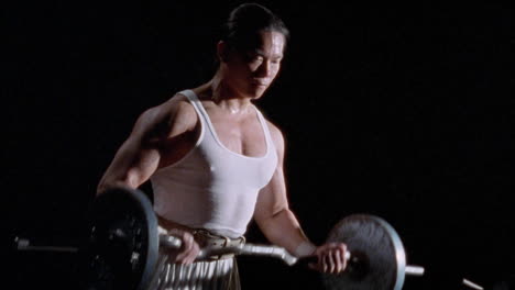 a man is exercising by lifting barbells