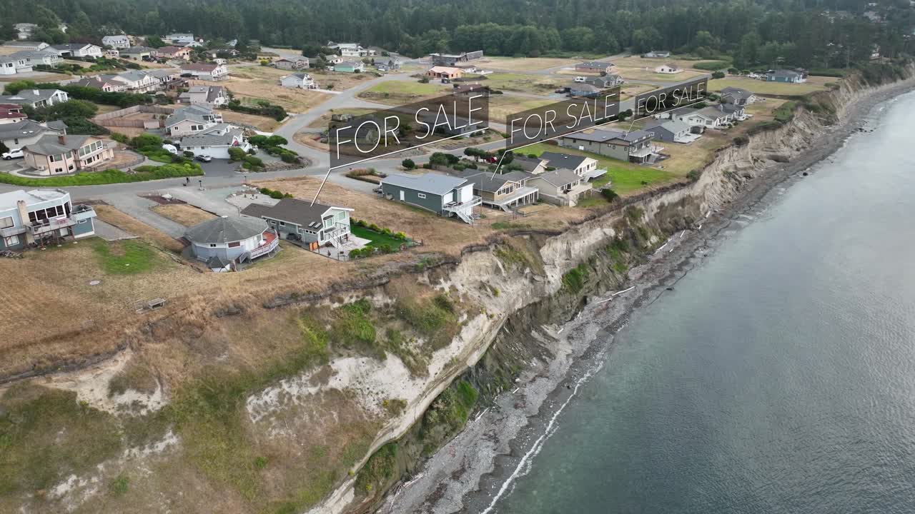 Aerial view of seaside houses with animated &amp;quot;FOR SALE&amp;quot; signs above the fancy houses