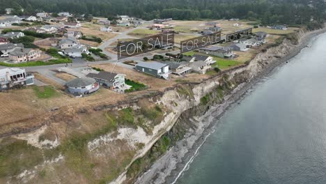 aerial view of seaside houses with animated "for sale" signs above the fancy houses