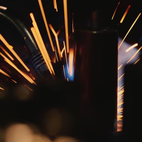 a welder in a protective helmet and clothes welds as sparks fly 9