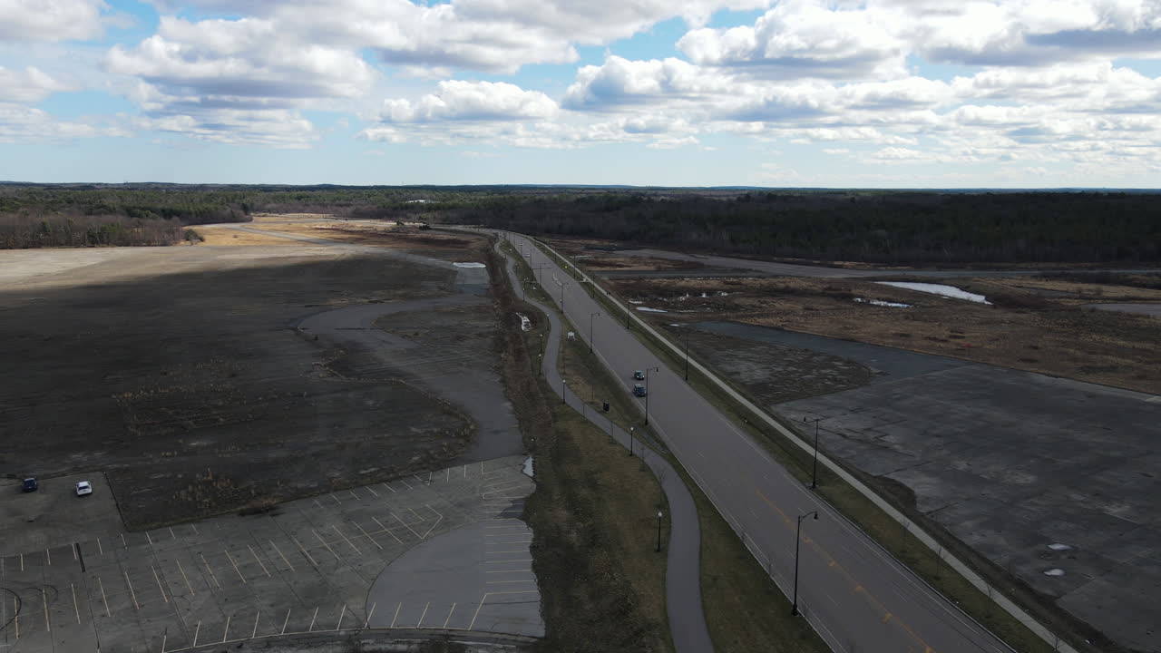 Remote location with only a few cars travelling down a freeway.  Apocalypse scenario.  Drone aerial static shot