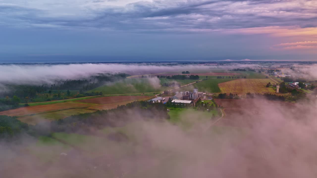 Above low level clouds over industrial modern farm rural countryside