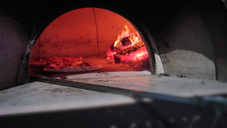pizza baking in a wood-fired oven