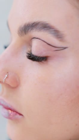 close-up of beauty makeup application and nose piercing