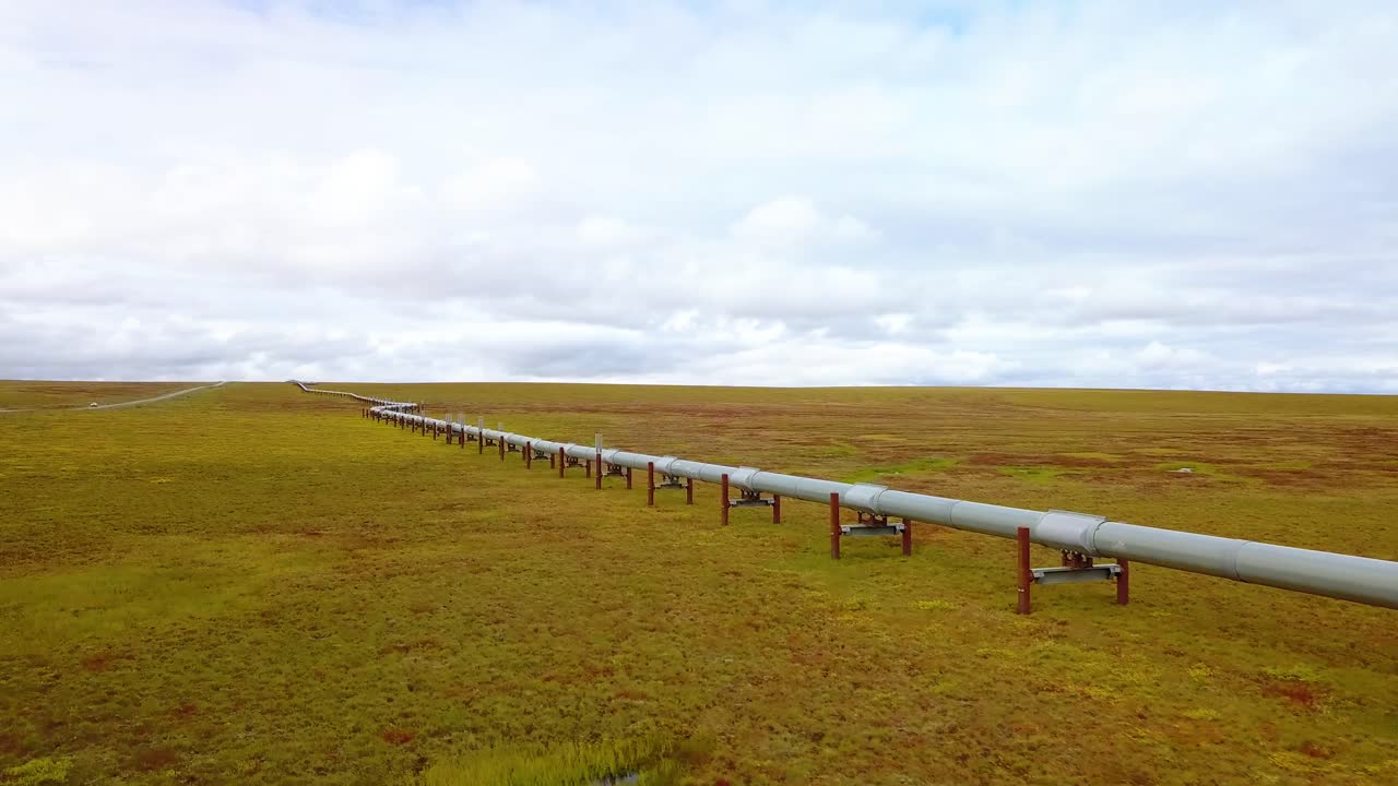 Aerial view of the Alyeska pipeline, oil transportation pipe following the Dalton Highway, cloudy day, in Alaska, USA