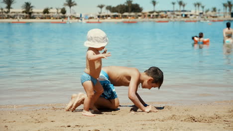 adorable cute children spending summer time at beautiful coastline.