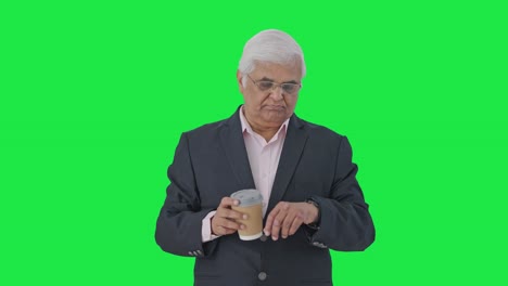 Indian-senior-manager-waiting-for-someone-Green-screen