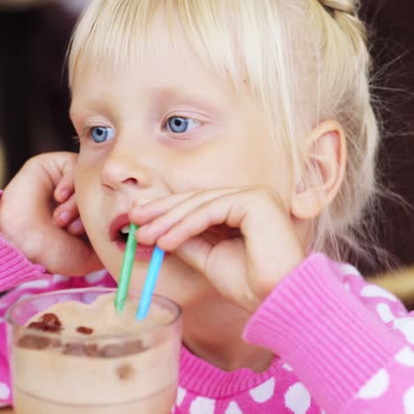 a child drinks from a straw