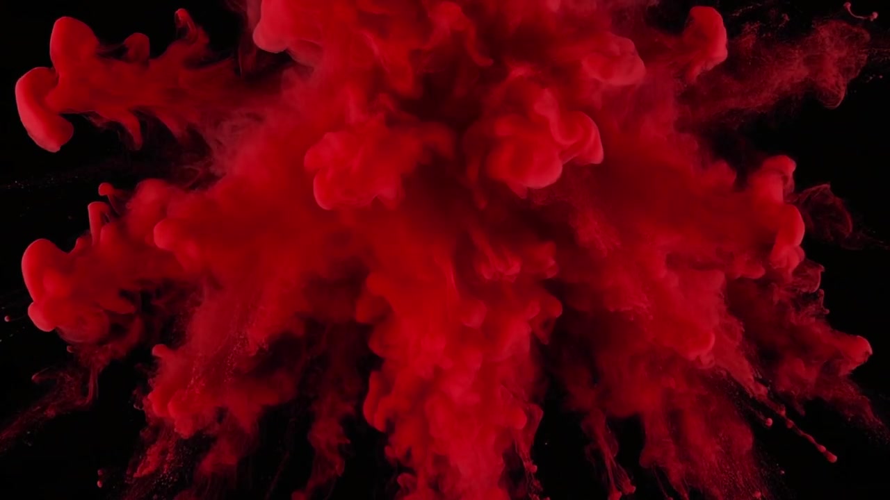 Vibrant Red Powder Explosion Against Black Background