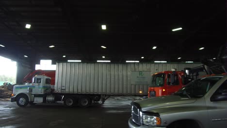 garbage truck dropping load at dump