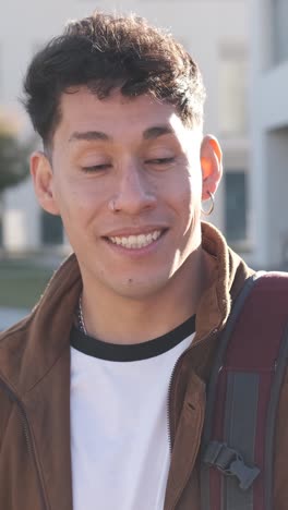 focus on a hispanic modern man talking with a friend outside the university