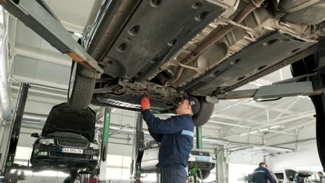 car undercarriage maintenance in a repair shop