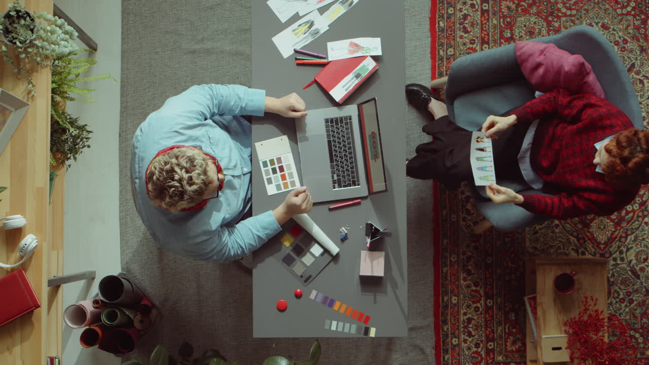 Designer and Female Customer Discussing Fashion Illustrations