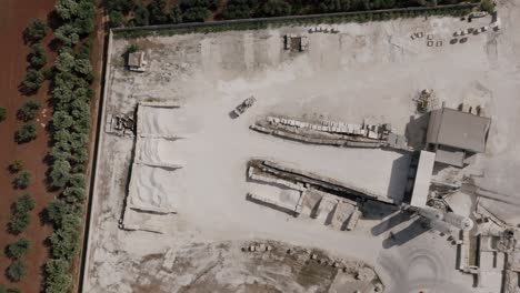 Top-down-aerial-footage-in-southern-Italy-of-a-truck-moving-gravel-back-and-forth